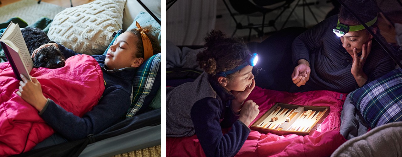 Child in a sleeping bag laying inside a tent reading. Mom and child with headlamps on, playing backgammon inside a tent.